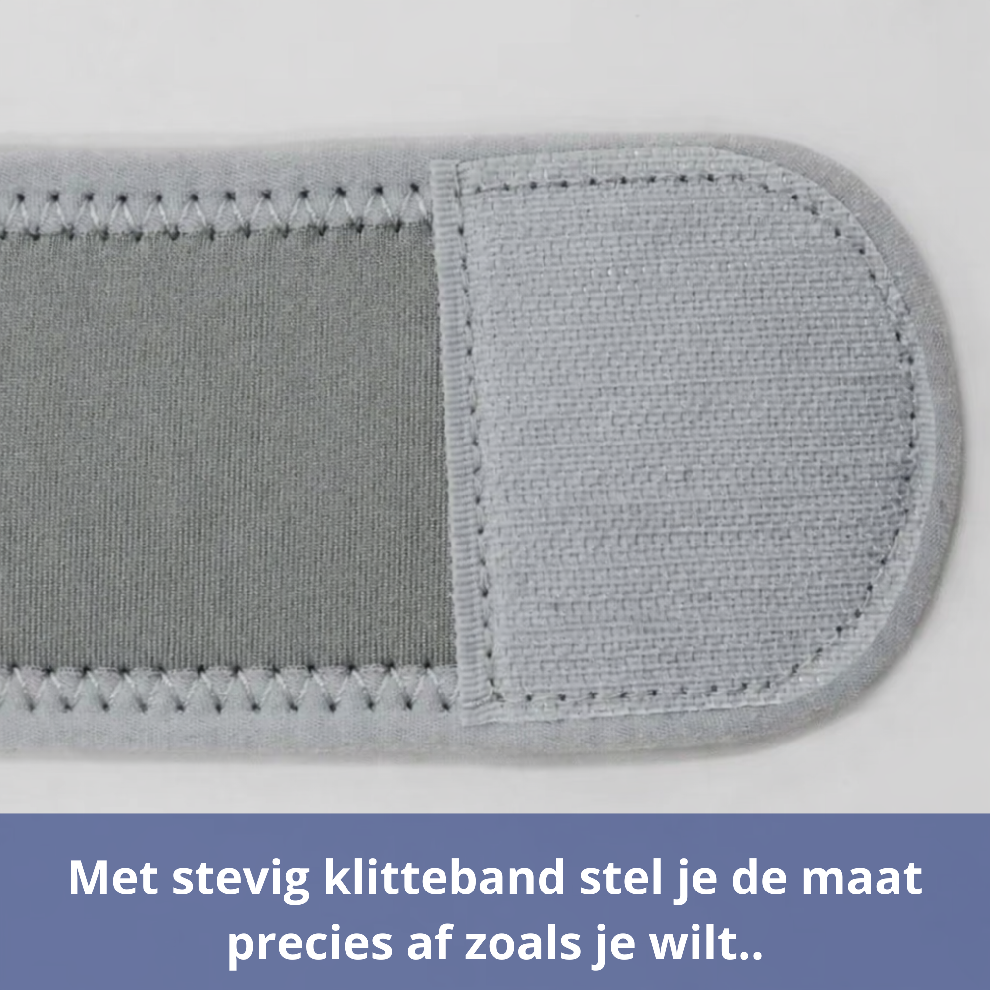 Close-up van grijze verstelbare band met stevig klittenband voor nauwkeurige maatverstelling.